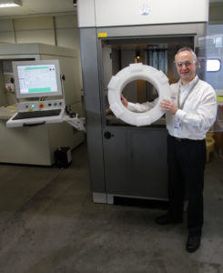 Cti's Richard Gould with an SLA replica pattern in front of the Stereolithography Additive Manufacturing machine that made it